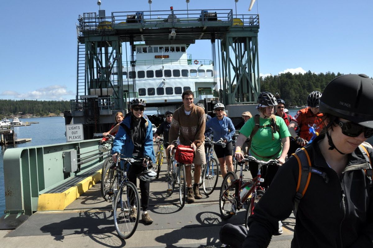 Bicyclists are first-class citizens the Washington State Ferry system, including these cyclists debarking at Friday Harbor on San Jan Island. They get on and off the ferries ahead of the motor vehicles. Cyclists going to the San Juan Islands from Anacortes pay the passenger fare plus a $2 surcharge during the non-peak times (October 1-April 30) and a $4 surcharge during the peak season (May 1-September 30). After paying the initial round-trip fare, inter-island travel is free. (Rich Landers)