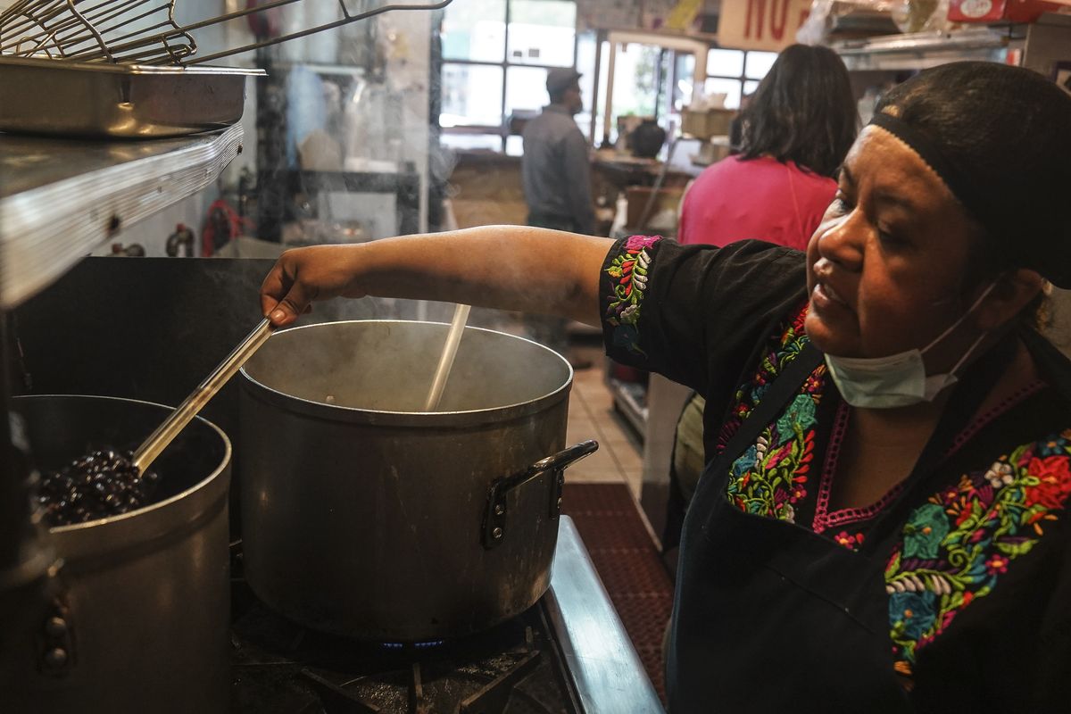 Natalia Méndez cooks in the kitchen of La Morada, an award winning Mexican restaurant she co-owns with her family in South Bronx, on Oct. 28 in New York.  (Bebeto Matthews)