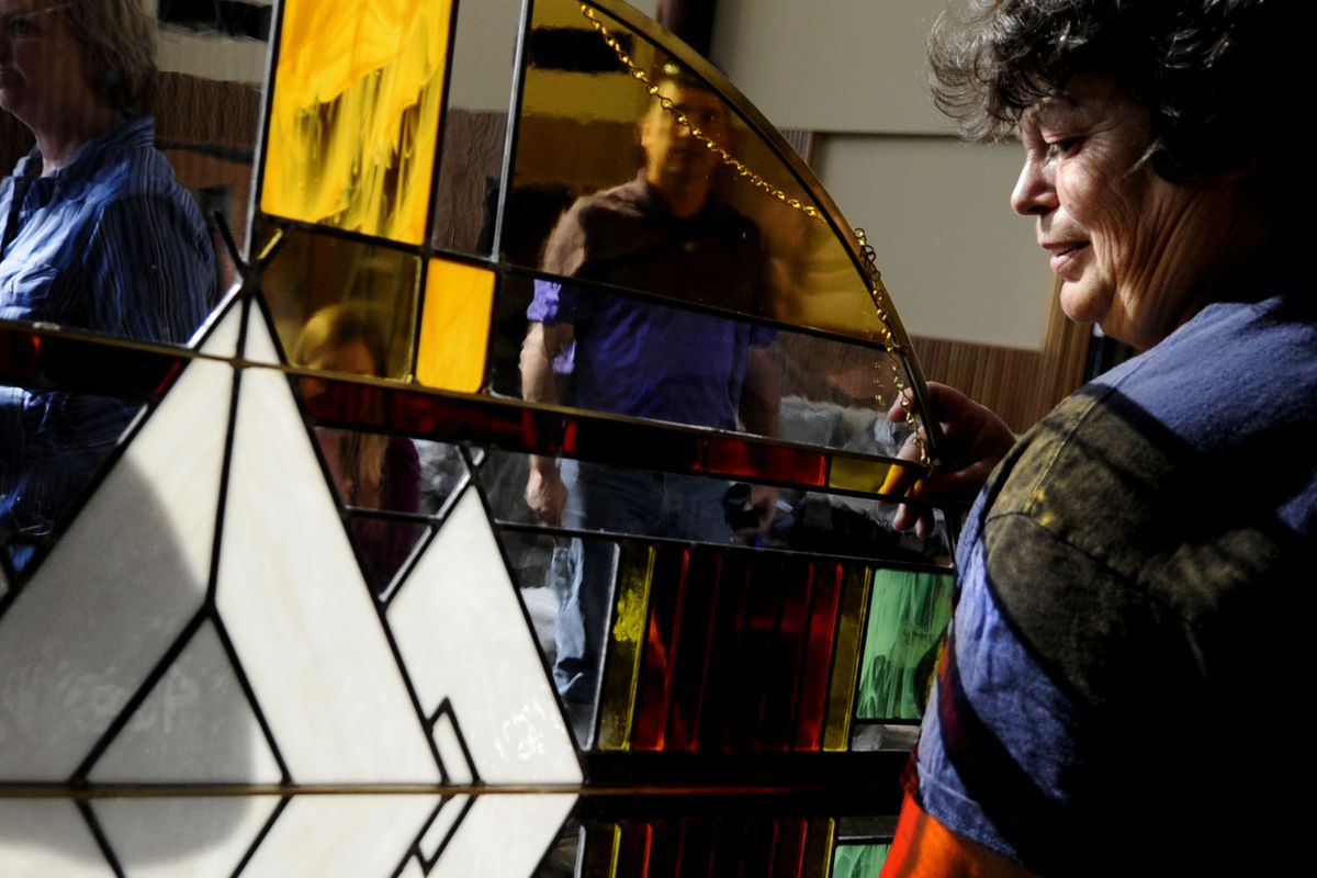 Kathy Quinn, right, housekeeping supervisor for Benewah Medical Center, moves a stained-glass piece into the lobby of the new facility on Oct. 9. The grand opening is Friday. (Kathy Plonka)