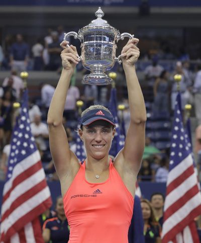 Angelique Kerber holds up the U.S. Open championship trophy. (Darron Cummings / Associated Press)
