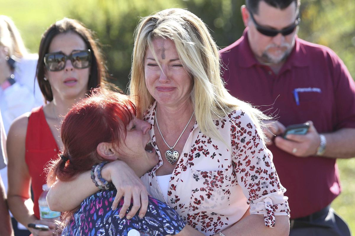 Parents wait for news after a reports of a shooting at Marjory Stoneman Douglas High School Wednesday, Feb. 14, 2018, in Parkland, Fla. (Joel Auerbach / AP)