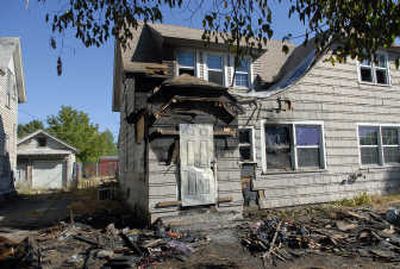 Debris litters the ground after a fire damaged a home at 1724 W. Nora.
(Dan Pelle / The Spokesman-Review)