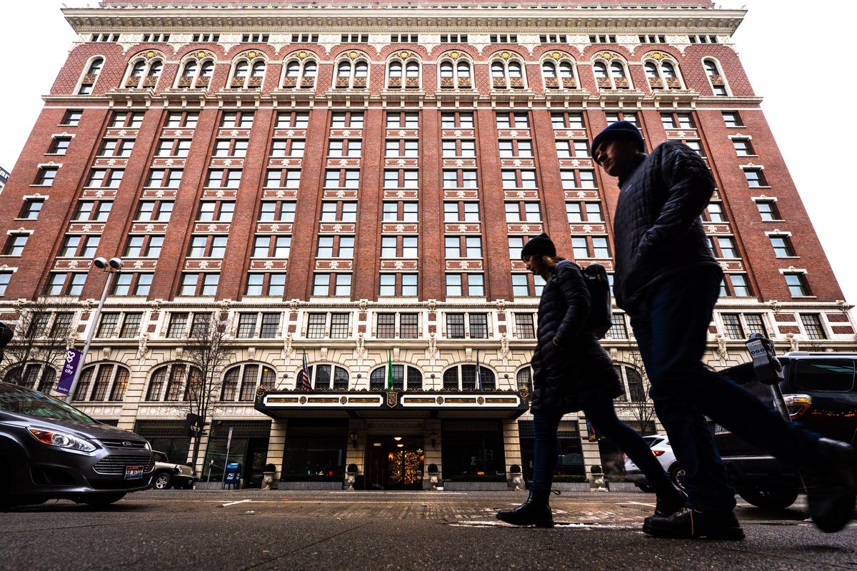 Pedestrians walk past the Historic Davenport Hotel in downtown Spokane, Tuesday, Dec. 7, 2021. Spokane Valley is seceding from the region’s tourism promotion area, an economic development effort that uses taxes on hotel rooms to fund marketing campaigns that bring visitors to the area.  (Colin Mulvany/The Spokesman-Review)