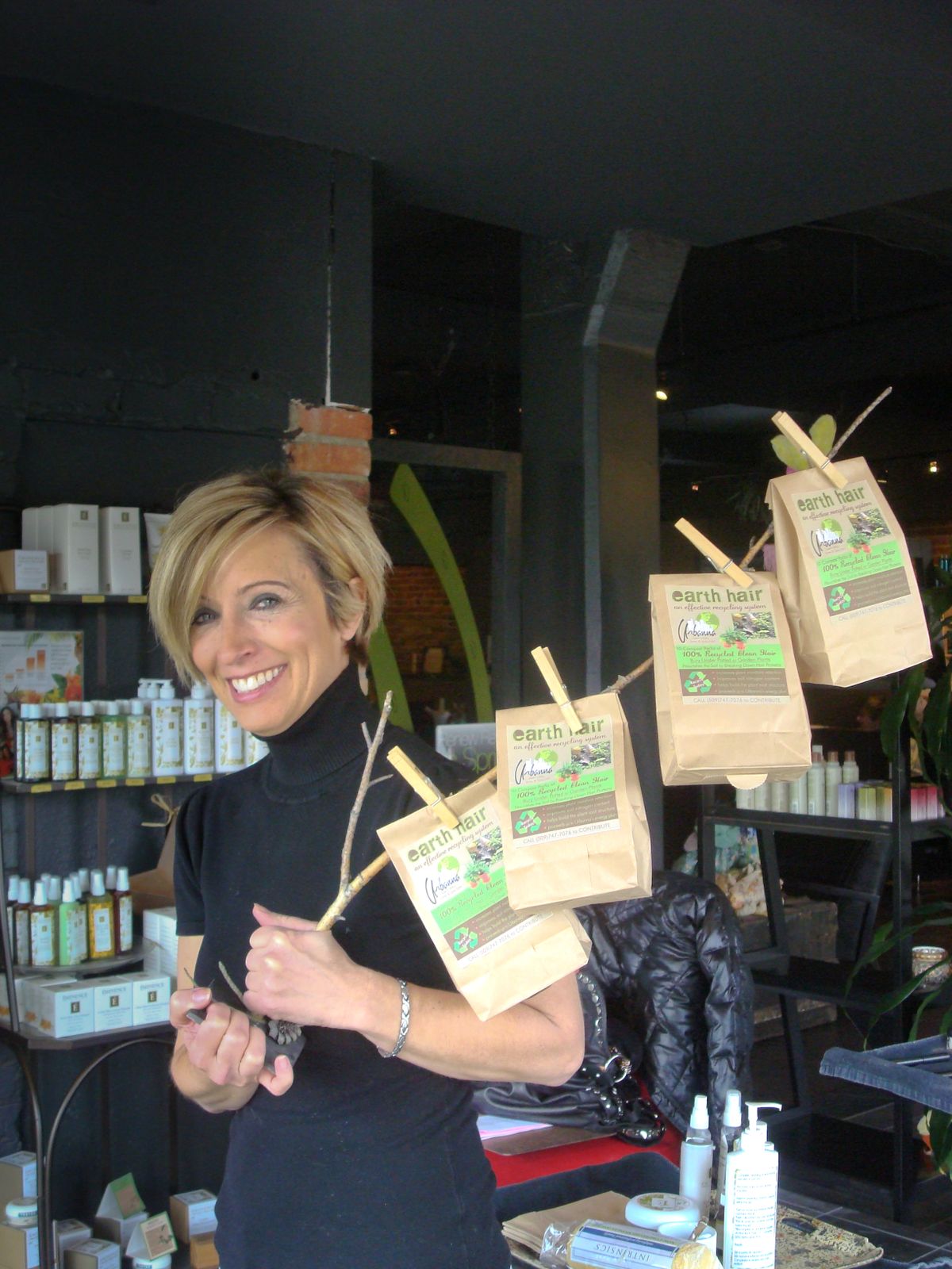 Linda Biel, owner of Urbanna Natural Salon and Spa, collects clipped hair and resells it for use in gardens. The hair is packed in teabag-sized containers that can be placed near plants. (Shallan Knowles / Down to Earth NW Correspondent)