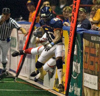 
Spokane's Charles Frederick bounces off the pads during a run in the first quarter. 
 (Christopher Anderson / The Spokesman-Review)