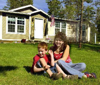
Monette Cushman and one of her sons, Zachary, 6, sit on the lawn provided by Stevens County corrections officers. 
 (John  Craig / The Spokesman-Review)