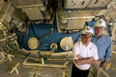 
Project manager Edward Moses, left, and associate chief George Miller stand in front of the target chamber of the National Ignition Facility at Lawrence Livermore National Laboratories in Livermore, Calif., earlier this year. 
 (Associated Press / The Spokesman-Review)