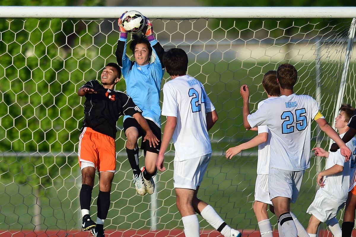 Central Valley goalkeeper Andrew Enzler stops a Davis shot on goal during a State 4A first-round match at CV on Wednesday. (TYLER TJOMSLAND PHOTOS)