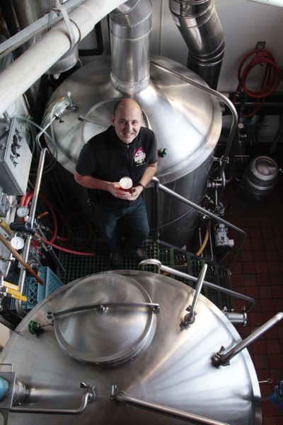 Doug Hindman, brewer at Elliott Bay Brewing Co., stands amid vats in his brewhouse, where the company brews a half-dozen organic, year-round beers. (Associated Press)