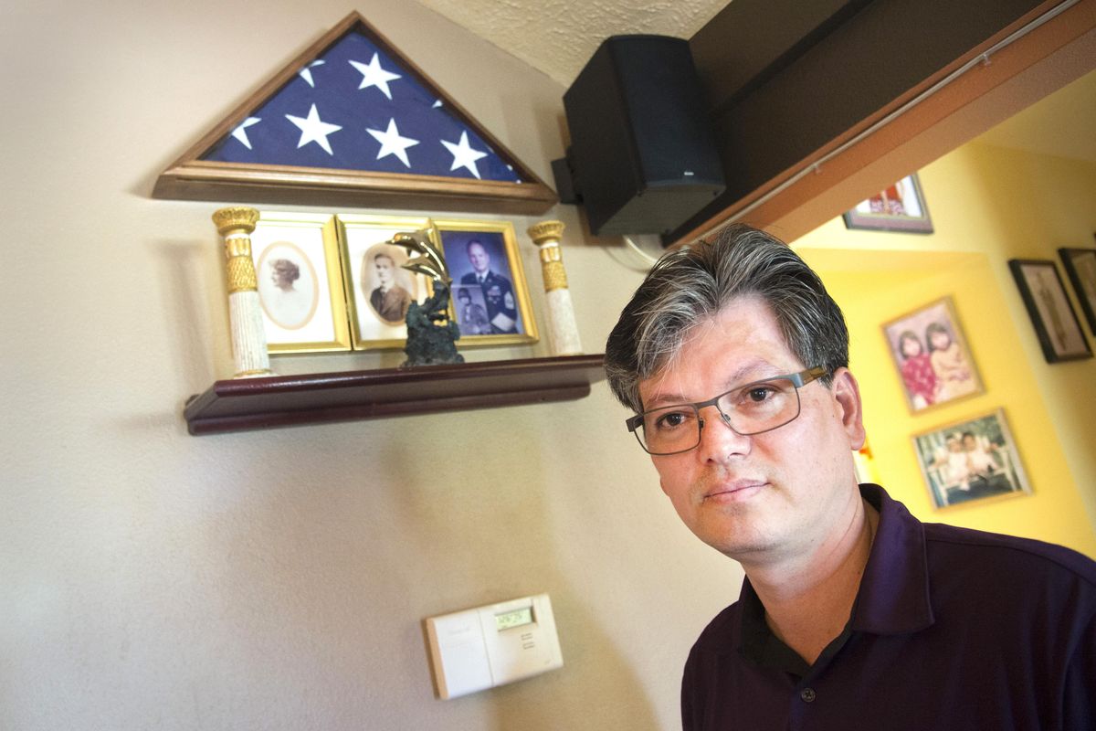 Jimmy Miller keeps a flag and a photo of his father in a special place at his Spokane Valley home Friday, June 3, 2016. Miller, an Amerasian whose father, James A. Miller, was an American soldier serving in Vietnam, helps to run a support group for Amerasian children which is working to try and get the last 300 or so Amerasian children out of Vietnam. Miller came to the U.S. 25 years ago after suffering great poverty through the 1970s and 1980s. JESSE TINSLEY jesset@spokesman.com (Jesse Tinsley / The Spokesman-Review)