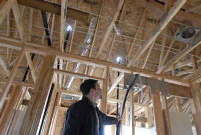 
Ben Deibel, of Greenstone Homes, inspects a coil and line set for heat pumps, air conditioning and supplemental heating at a house under construction in Liberty Lake. Greenstone recently pledged to build only Northwest Energy Star compliant dwellings. 
 (Photos by J. BART RAYNIAK / The Spokesman-Review)