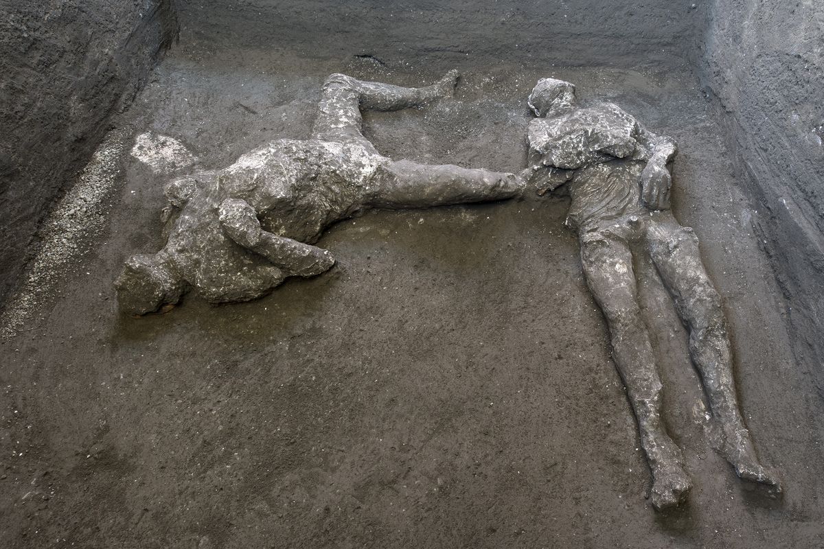 The casts of what are believed to have been a rich man and his male slave fleeing the volcanic eruption of Vesuvius nearly 2,000 years ago, are seen in what was an elegant villa on the outskirts of the ancient Roman city of Pompeii destroyed by the eruption in 79 A.D., where they were discovered during recents excavations, Pompeii archaeological park officials said Saturday, Nov. 21, 2020. (HOGP)