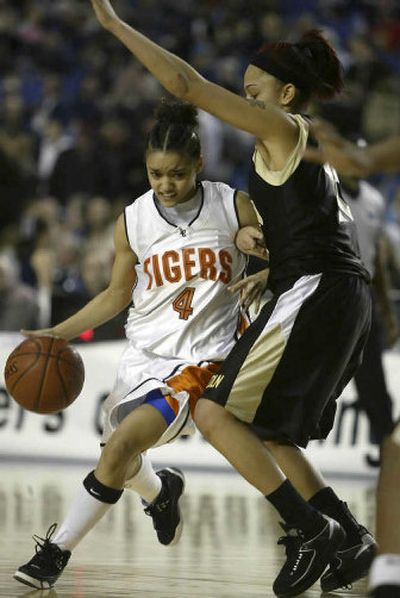 
Lewis and Clark's Ren Mallory (4) drives past Lincoln's  Vanessa Baines during the fourth period of the Tigers' 55-53 4A state tournament quarterfinals earlier this month in Tacoma.
 (Jim Bryant Special to / The Spokesman-Review)