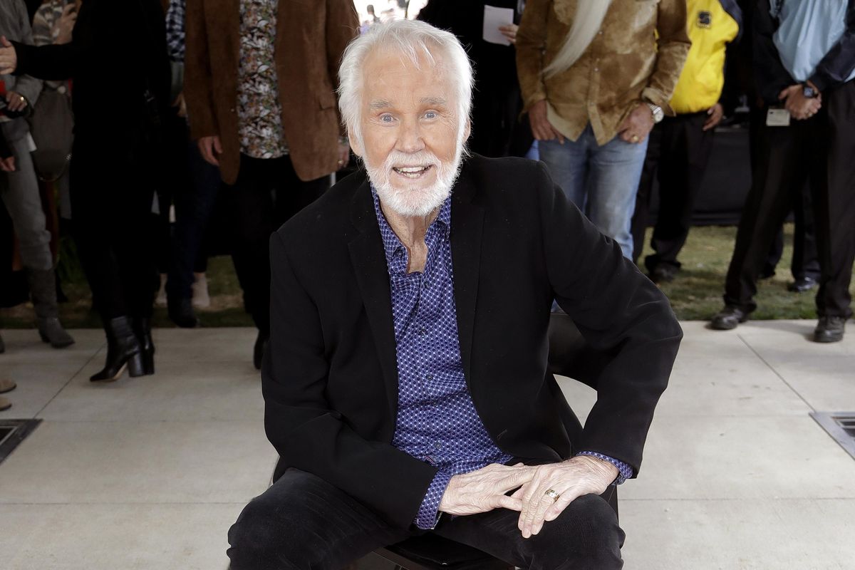 In this Oct. 24, 2017 photo, Kenny Rogers poses with his star on the Music City Walk of Fame in Nashville, Tenn. Actor-singer Kenny Rogers, the smooth, Grammy-winning balladeer who spanned jazz, folk, country and pop with such hits as “Lucille,” “Lady” and “Islands in the Stream” and embraced his persona as “The Gambler” on record and on TV died Friday night, March 20, 2020. He was 81. (Mark Humphrey / Associated Press)