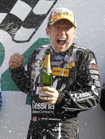 Jamie McMurray gets sprayed with champagne in Victory Lane. (Associated Press)