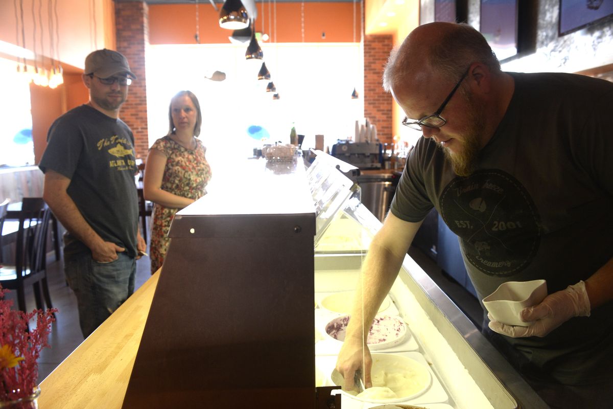 Ben Bradley scoops up sorbet for customers at Brain Freeze Creamery in Kendall Yards. The creamery, which has supplied ice cream to The Scoop and various restaurants around the area, has opened its first retail establishment in Kendall Yards. (Jesse Tinsley)