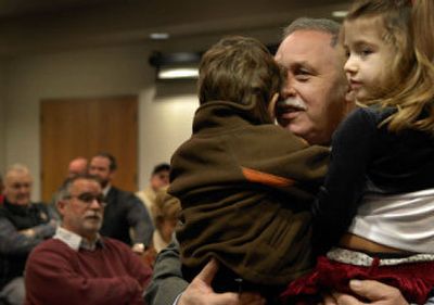 
New Kootenai County Commissioner Rich Piazza gets  hugs from his grandchildren, Demarko  and Marriah Piazza, before the swearing in ceremony Monday at county offices. The new commission's first regular meeting is today at 2 p.m. in the county Administration Building.  
 (Kathy Plonka / The Spokesman-Review)