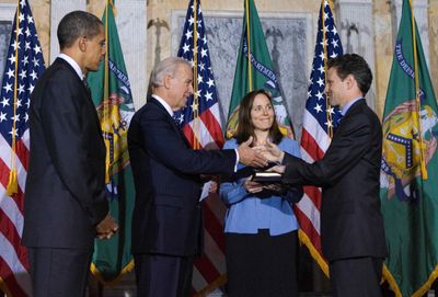 President Barack Obama watches as Vice President Joe Biden shakes hands with Treasury Secretary Timothy Geithner after swearing him in Monday, as his wife, Carole Geithner, looks on.  (Associated Press / The Spokesman-Review)