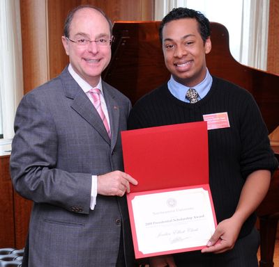 Lewis and Clark High School graduate Jordan Clark, right, is pictured with Northeastern University President Joseph Aoun accepting  the presidential scholar award. Craig Bailey/NU Photography (Craig Bailey/NU Photography / The Spokesman-Review)