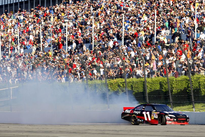 Denny Hamlin managed to hit the wall during his celebratory burnout after winning the Gillette Fusion ProGlide 500 at Pocono Raceway. Team owner Joe Gibbs learned of the damage to the car Hamlin has taken to Victory Lane in Martinsville and Darlington during a post-race press conference. “I got to tell ya’ll the truth, I didn’t know he hit the wall until I got here,” Coach Gibbs said. “We’ll work it out.” (Photo courtesy Chris Totman/Getty Images for NASCAR) (Chris Trotman / Getty Images North America)