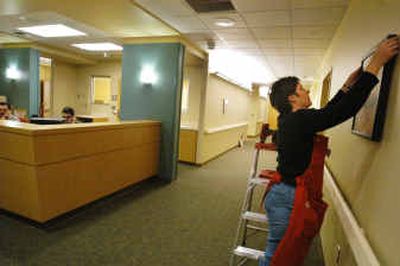 Tracy Ruhs hangs a picture on the wall in the maternity wing of the new Pullman Memorial Hospital addition. Ruhs, along with other employees of Design Effects Interiors in Pullman, will hang more than 200 pictures on the walls of the new hospital. Providing a more comfortable atmosphere for patients and visitors is one of the goals of the new hospital.
(Kevin Nibur/Spokesman-Review / The Spokesman-Review)