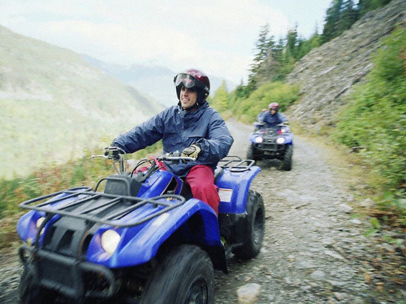  Recreationists ride ATVs on a national forest route.