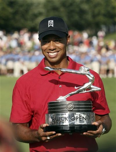 Tiger Woods holds the winner's trophy after the final round of the Buick Open golf tournament at Warwick Hills in Grand Blanc, Mich., Sunday, Aug. 2, 2009. (AP Photo/Carlos Osorio) (Carlos Osorio / AP News)
