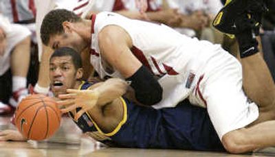 
Associated PressCalifornia's Jamal Boykin, bottom, and Stanford's Brook Lopez go after a loose ball.
 (Associated Press / The Spokesman-Review)