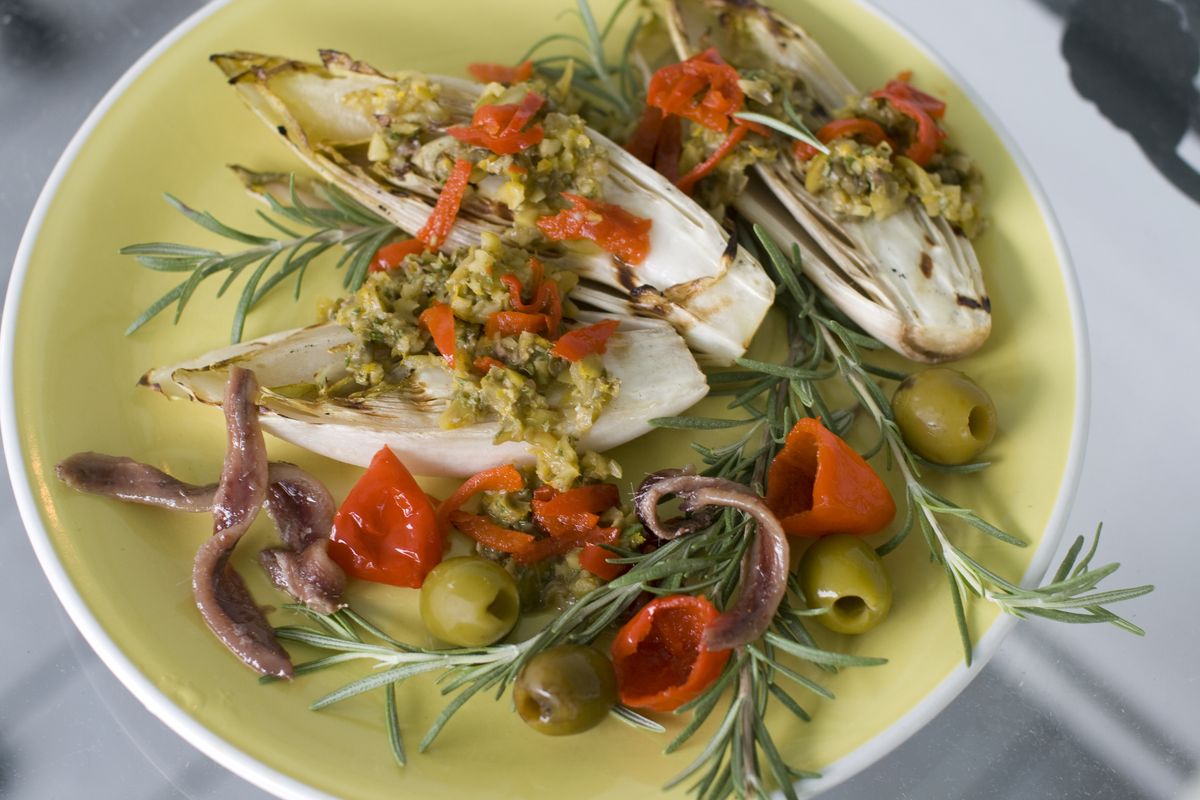 The recipe for Orange Anchovy Tapenade Over Grilled Endive takes only 20 minutes to prepare. (Associated Press)