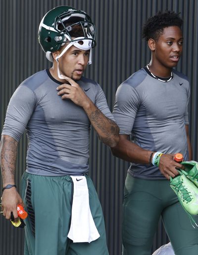 The completion of a single math test by Oregon quarterback Vernon Adams (left with Travis Jonsen) captured fans’ attention on Thursday. (Andy Nelson)