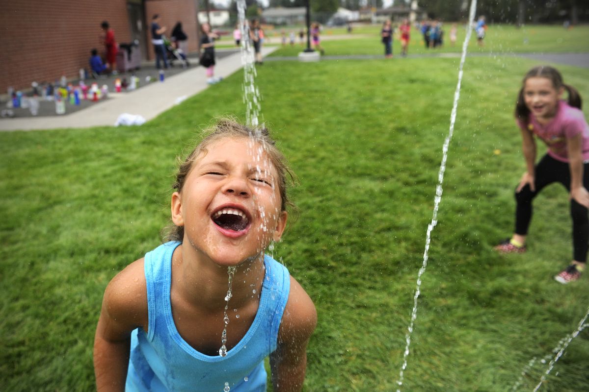 First-grader Jewel Malmoe gets a drink Thursday during the after-school cross-country program at Linwood Elementary. Active for Youth, a volunteer effort of school personnel and parents, now sponsors the cross-country program at Spokane schools. (Jesse Tinsley)