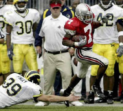 
Ohio State's Ted Ginn dodges Adam Finley during an 82-yard TD on a punt return. 
 (Associated Press / The Spokesman-Review)