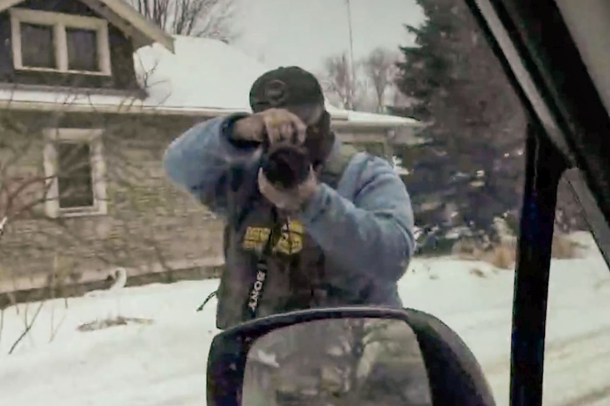 In a still made from video, Katie Henly records an ICE agent from her vehicle. Protesters in Minneapolis and St. Paul said in sworn statements that they were singled out by agents who demonstrated that they knew where they lived.  (New York Times)