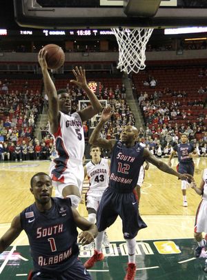 Gonzaga's Gary Bell, Jr. puts up a shot against South Alabama's Antoine Allen in the first half. (Associated Press)
