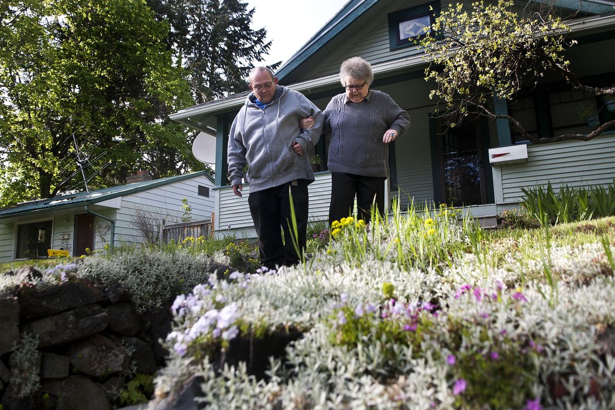 Vikki Moormann walks with help from her son Ryen Moormann from his home to hers in Coeur d