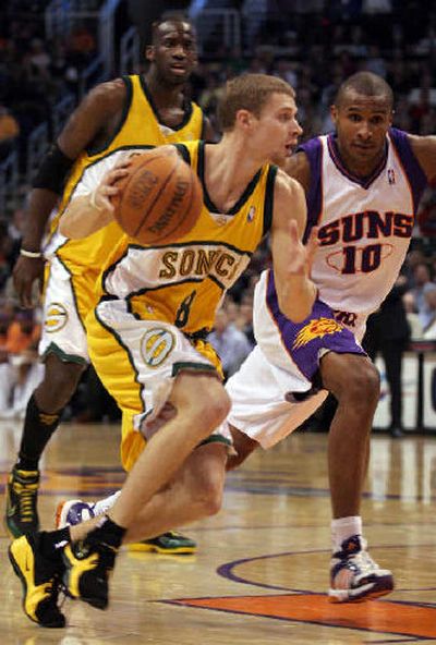 
Seattle's Luke Ridnour drives against Phoenix's Leandro Barbosa on Tuesday. 
 (Associated Press / The Spokesman-Review)