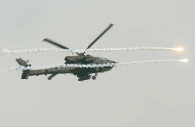 
A U.S. military Apache helicopter drops flares to protect itself from a missile attack over  downtown Baghdad on Wednesday as it secures an American military convoy hit by a roadside bomb. Associated Press
 (Associated Press / The Spokesman-Review)