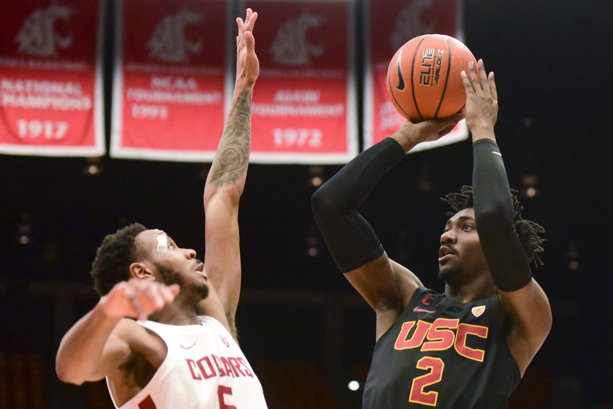 Southern California guard Jonah Mathews  shoots as Washington State forward Marvin Cannon  defends during the first half Saturday  in Pullman. (Pete Caster / AP)