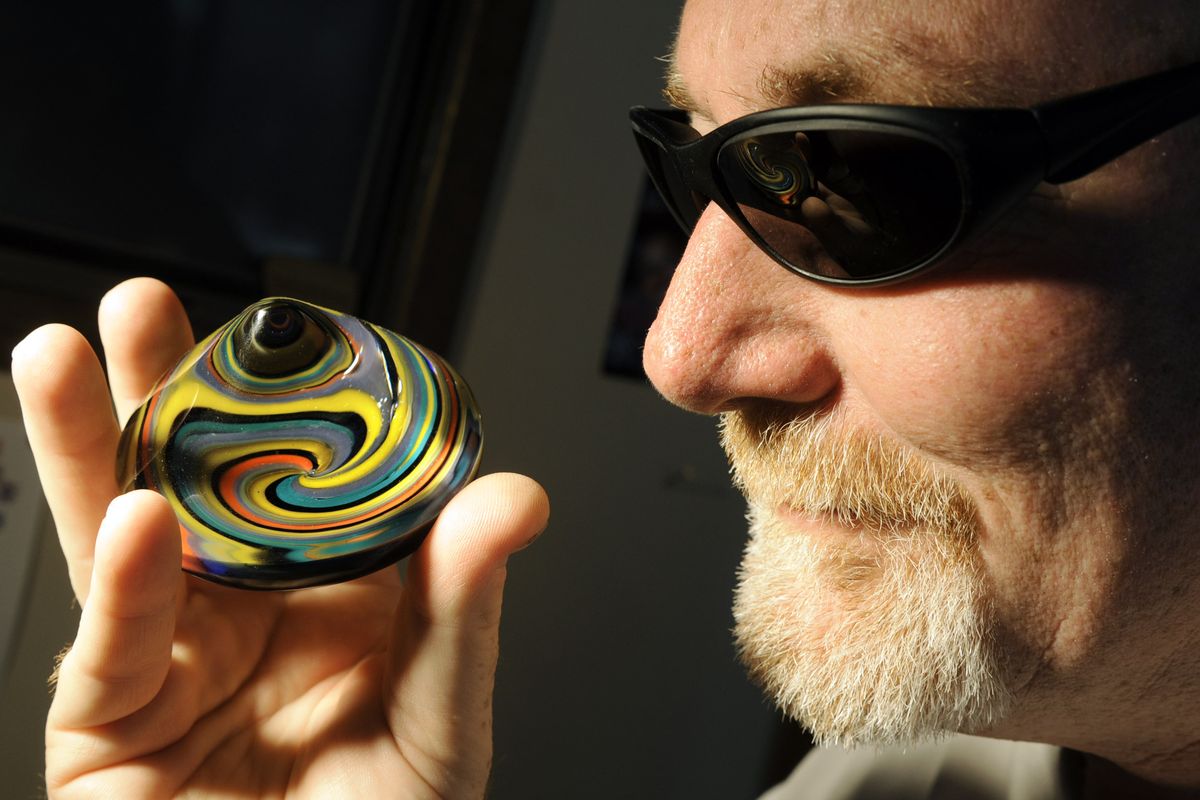 Lampworking artist Ken Frybarger uses melted colored rods to create pendants, marbles and this paperweight in his Indian Trail neighborhood home.  (Dan Pelle)