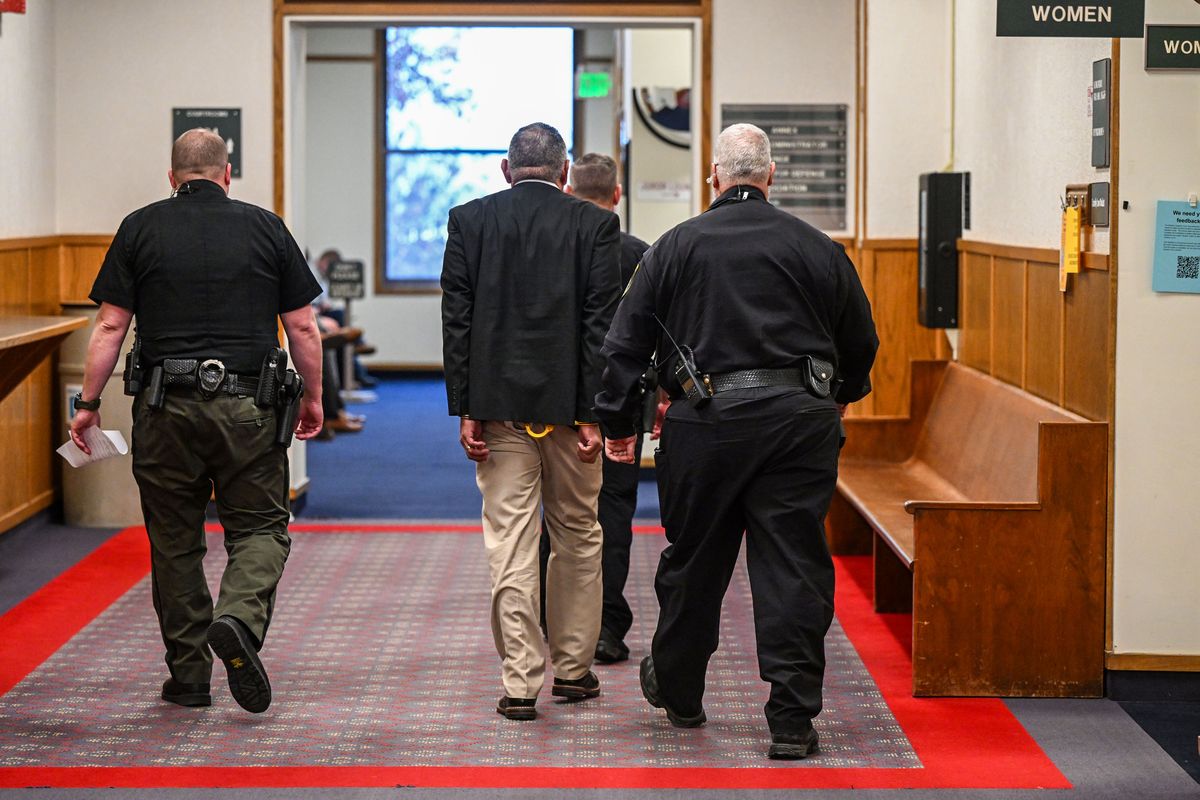 Richard Aguirre, 59, center, is led down the hallway after being convicted, Tuesday, Dec. 26, 2023, for the 1986 killing of Ruby Doss, 27. Judge Jeremey Schmidt ruled Aguirre guilt of first-degree murder.  (DAN PELLE/THE SPOKESMAN-REVIEW)