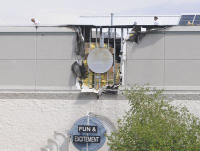 People  work on top of the Spokane Valley Mall, where an electrical fire  damaged the facade Monday morning. The fire was  above Tilt, a video arcade. (Jesse Tinsley / The Spokesman-Review)