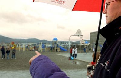 
Coeur d'Alene schools employee Candy Dougall looks Monday as a student  points to boys who she said were name-calling during recess at Ramsey Elementary. 
 (Kathy Plonka / The Spokesman-Review)