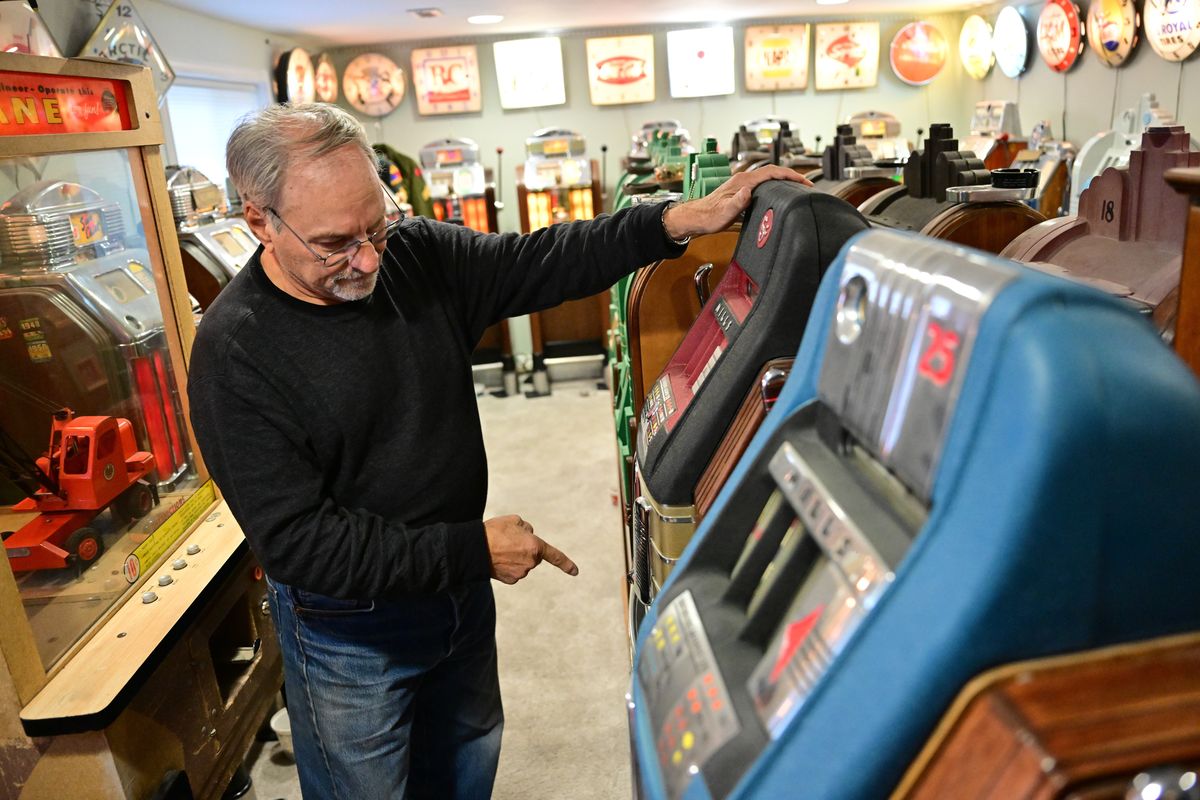 Terry Burns shows off his collection of vintage slot machines on Oct. 24 at his home in Spokane Valley.  (Tyler Tjomsland/The Spokesman-Review)