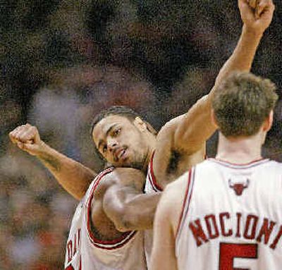 
Chicago's Tyson Chandler, center, gets a victory hug from teammate Antonio Davis.
 (Associated Press / The Spokesman-Review)
