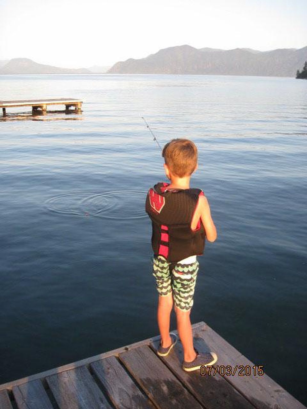 Kathy Lefor’s grandson, Carson Debban,  fishes from a dock on the family property in July 2015. (COURTESY OF KATHY LEFOR)