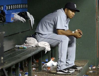 
Seattle Mariners second baseman Jose Lopez sits in the dugout following the 10-6 loss to Texas. The Rangers swept the Mariners in four-straight games. 
 (Associated Press / The Spokesman-Review)