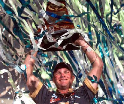 
Luke Clausen hoists his Bassmaster Classic trophy after winning in February. 
 (Associated Press / The Spokesman-Review)