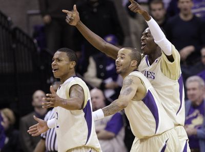 UW’s Isaiah Thomas, left, Venoy Overton and Justin Holiday celebrate during their victory over UCLA on Saturday. (Associated Press / The Spokesman-Review)