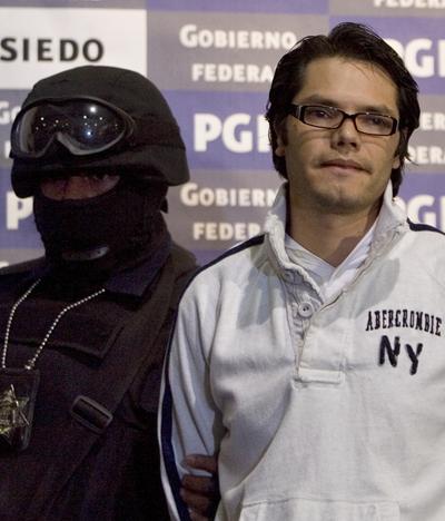 A federal police officer escorts alleged Mexican drug trafficker Vicente Carrillo Leyva in Mexico City on Thursday.  (Associated Press / The Spokesman-Review)