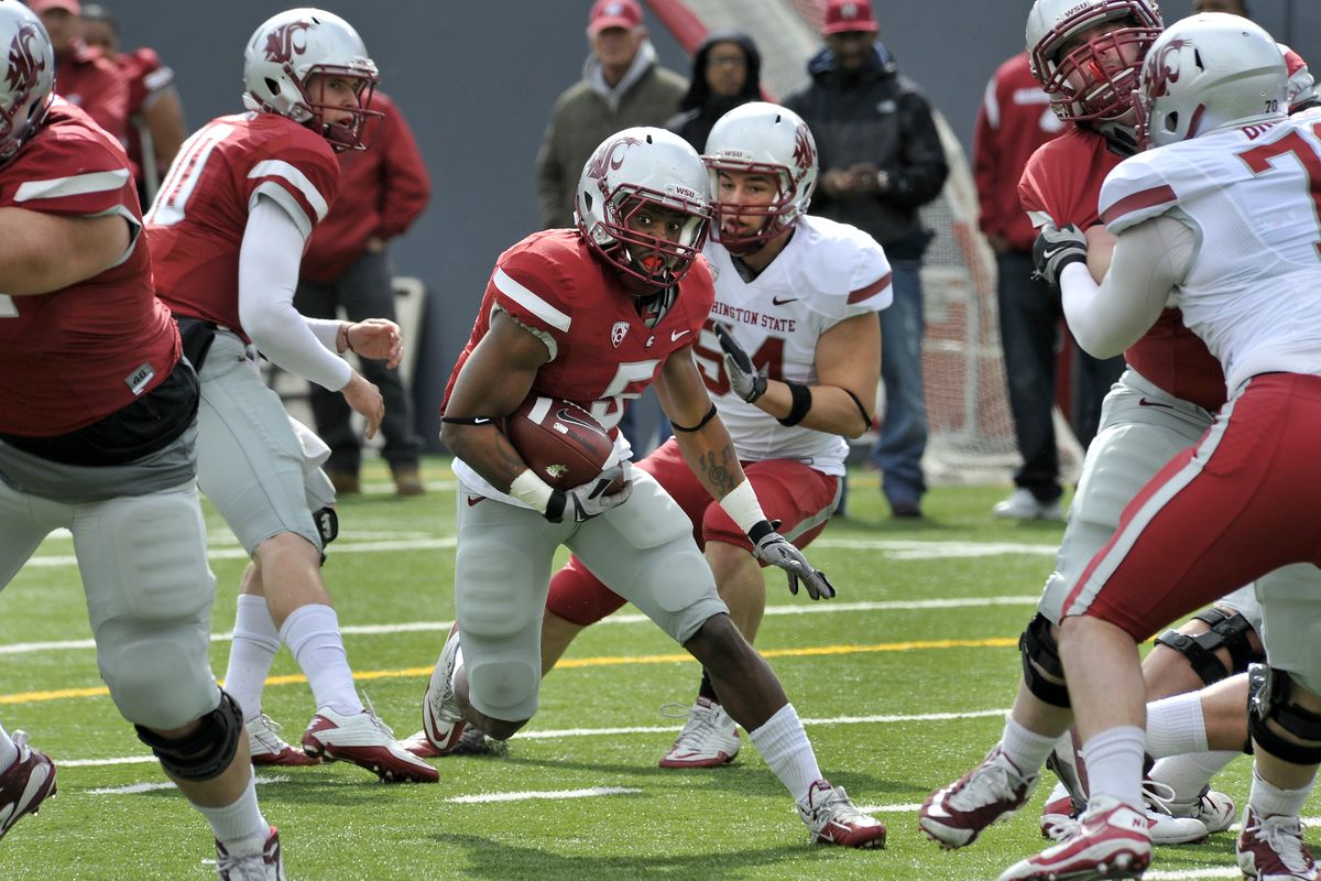 Washington State University running back, Rickey Galvin (5), blasts through a gaping hole in the line after taking a hand off from QB, Jeff Tuel (10), during the WSU spring scrimmage, April 16, 2011, at Joe Albi Stadium in Spokane, Wash. (Dan Pelle / The Spokesman-Review)